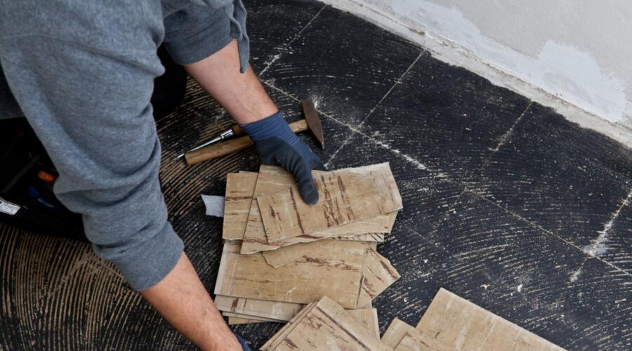 person removing tiles glue from concrete