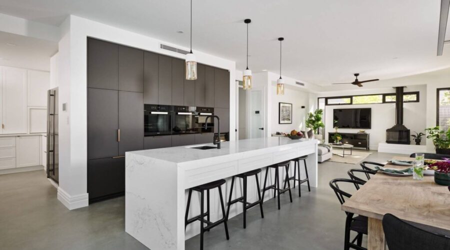 a big hall room containing living room, kitchen and dining space together